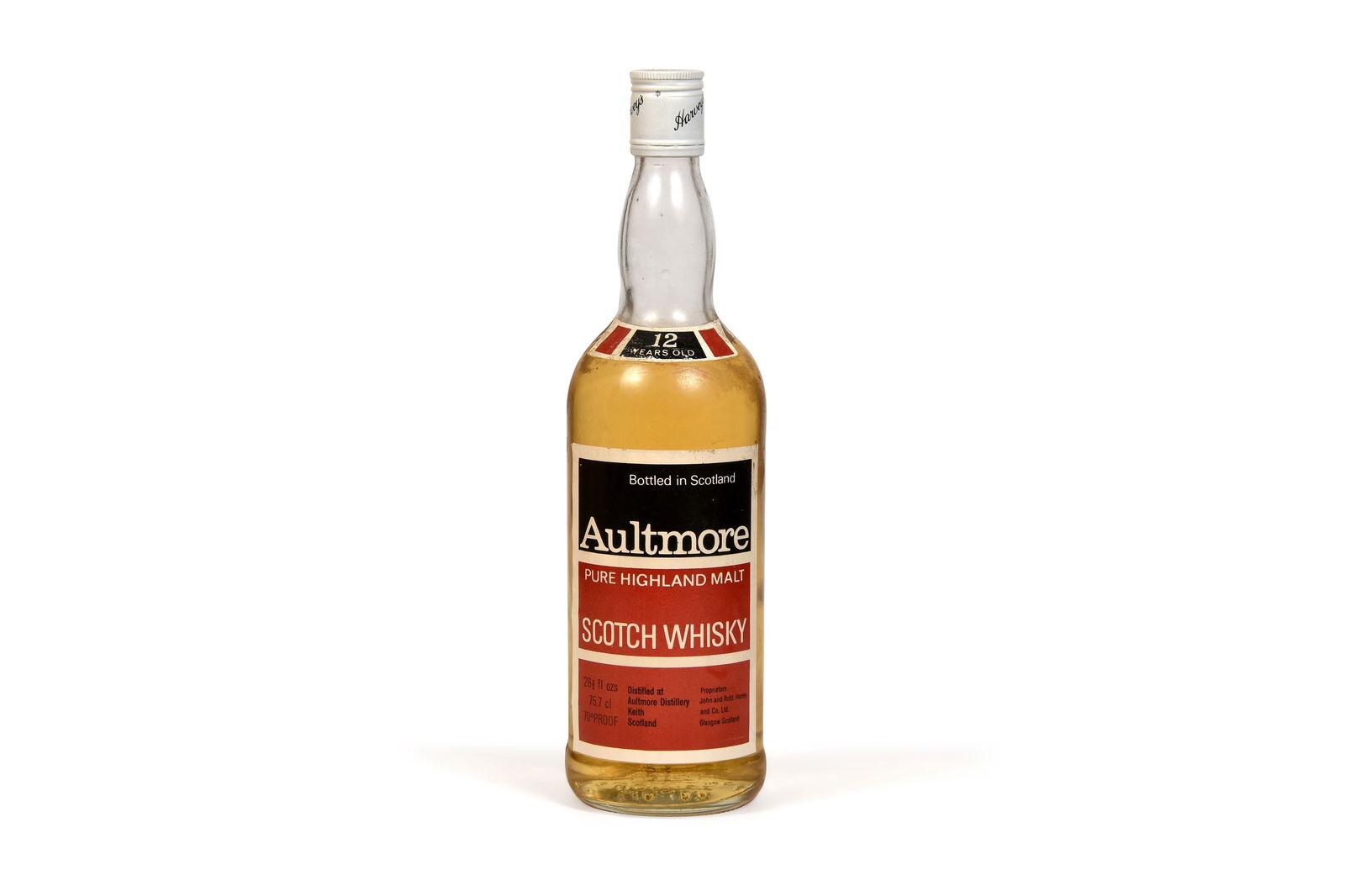 AULTMORE 12 YEAR OLD John & Robert Harvey: AULTMORE 12 YEAR OLDJohn & Robert Harvey White, Black and Red Label with White Cap labelled "Harvey's"43% abv Fill level - High Shoulder75cl 75clQty: 1