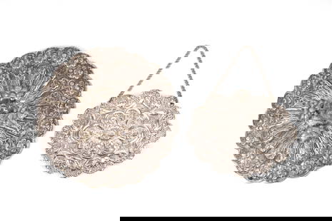 TWO OTTOMAN TURKISH REPOUSSÉ SILVER MIRRORS Turkey, early 20th century: TWO OTTOMAN TURKISH REPOUSSÉ SILVER MIRRORS Turkey, early 20th century Comprising one circular mirror with a handle formed as a bird and one oval mirror with a chain for suspension attached to