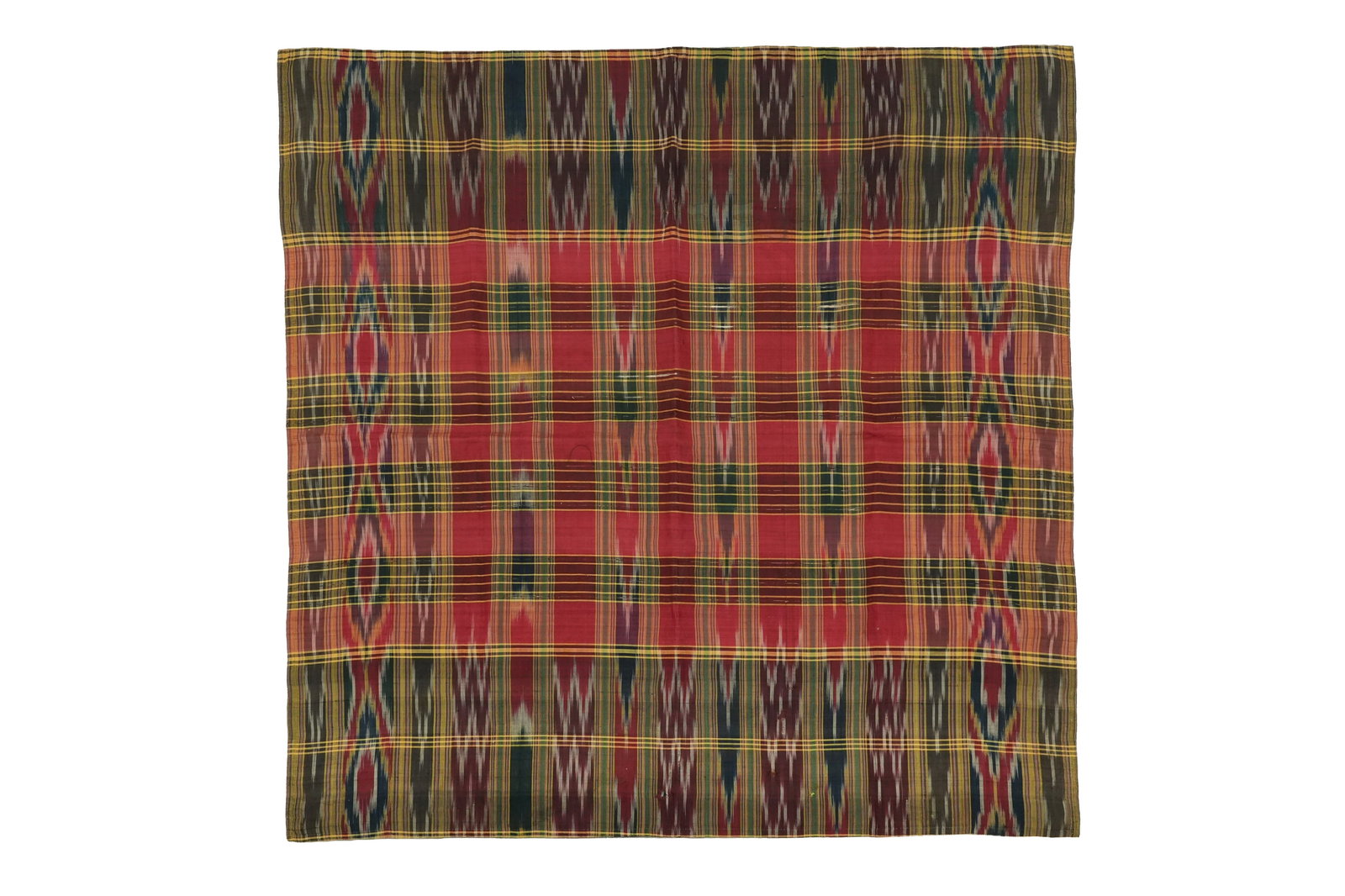 A SQUARE IKAT TEXTILE Central Asia, early 20th century: A SQUARE IKAT TEXTILE Central Asia, early 20th century A SQUARE IKAT TEXTILECentral Asia, early 20th century Square ikat textile in the shades of red, burgundy, yellow and green on a silk panel. The b