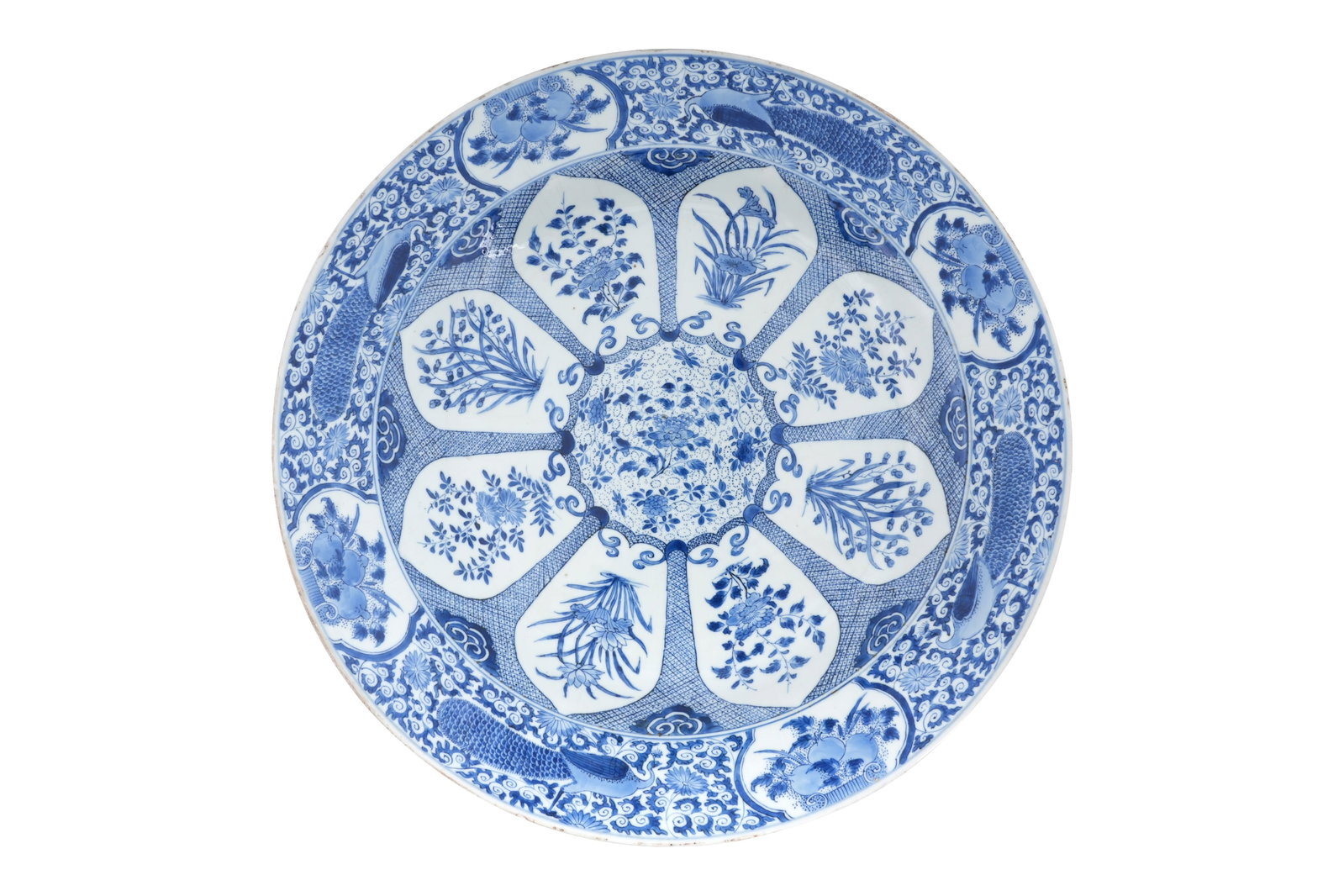 A VERY LARGE CHINESE BLUE AND WHITE ?PEACOCK PATTERN? CHARGER Kangxi period: A VERY LARGE CHINESE BLUE AND WHITE ?PEACOCK PATTERN? CHARGER Kangxi period Painted with a design of a blossom reserved on a scaly ground, the centre and each petal containing a different floral spray