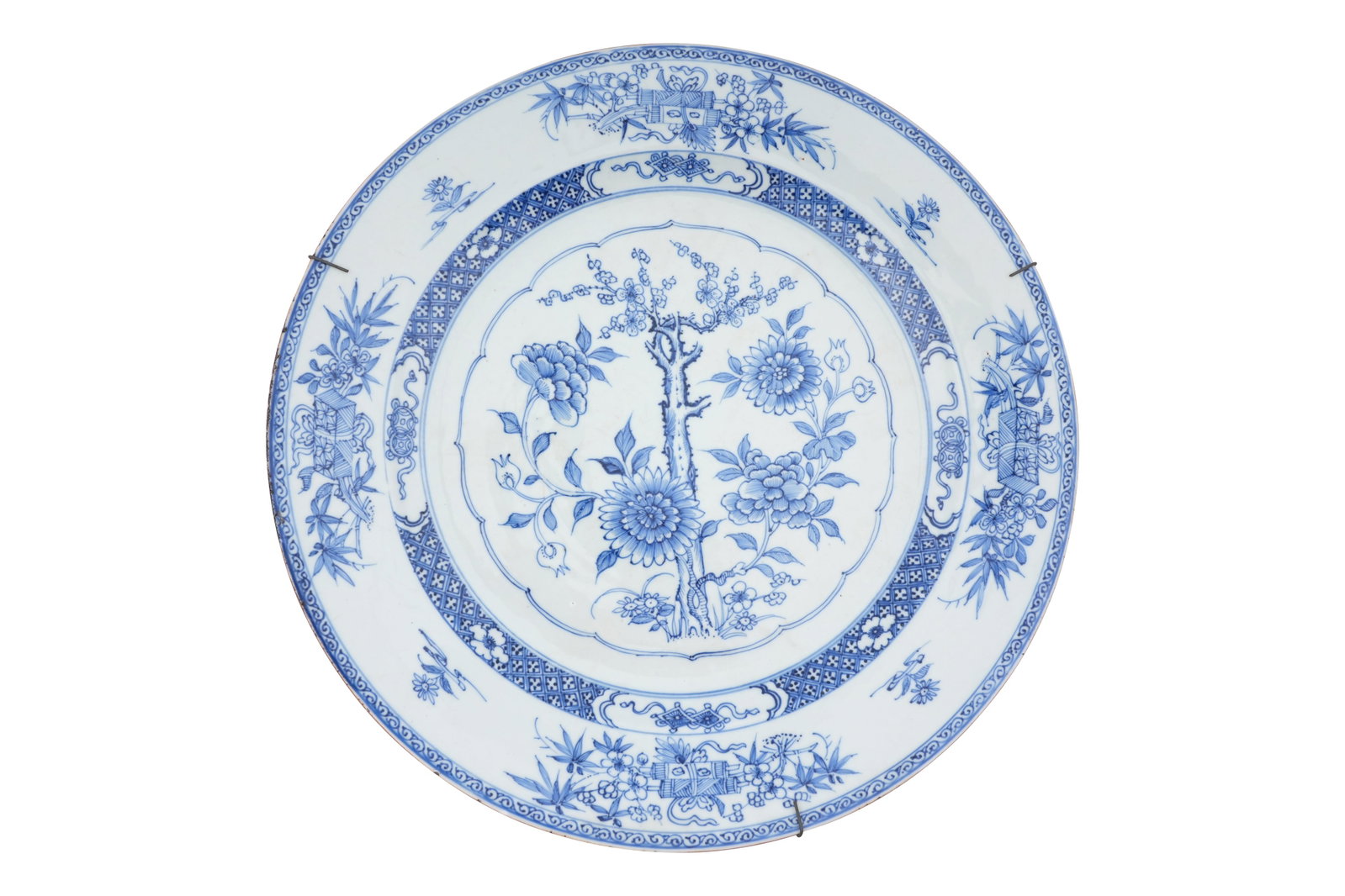 A LARGE CHINESE BLUE AND WHITE CHARGER Qianlong period, 18th century: A LARGE CHINESE BLUE AND WHITE CHARGER Qianlong period, 18th century Painted to the centre with a scalopped cartouche containing a prunus tree and chrysanthemums, surounded by bands of geom