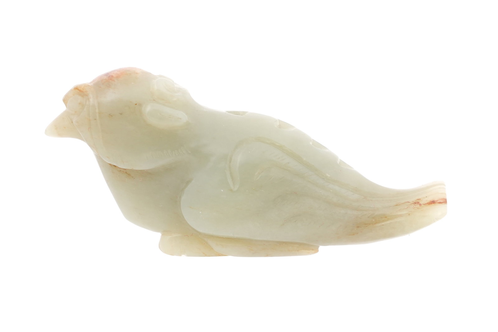 A CHINESE CELADON JADE ARCHAISTIC CARVING OF A BIRD Possibly late Qing dynasty: A CHINESE CELADON JADE ARCHAISTIC CARVING OF A BIRD Possibly late Qing dynasty Looking forward, with legs tucked underneath the body and plumage arranged in stylised scrolls, small russet inclusions t