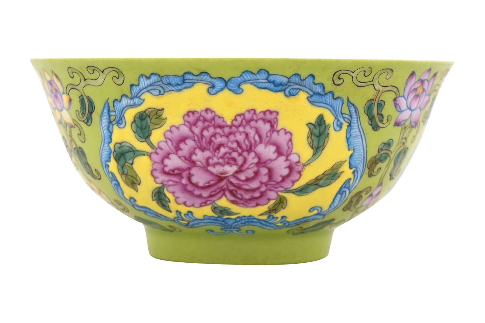 A CHINESE ENAMELLED FAMILLE ROSE LIME-GROUND BOWL 20th century: A CHINESE ENAMELLED FAMILLE ROSE LIME-GROUND BOWL 20th century Painted to the exterior in colourful enamels with pink flowerheads on a yellow ground enclosed within feathery scrolls, all reserved on a