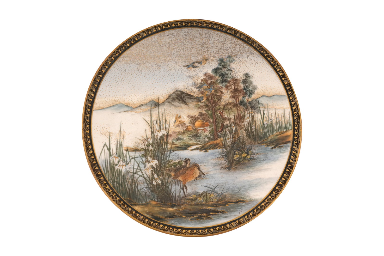 A JAPANESE SATSUMA DISH BY EIZAN Meiji period or later: A JAPANESE SATSUMA DISH BY EIZAN Meiji period or later Painted with a pair of snipes wading along the edge of the water among reeds and wild irises, a thatched hut among the trees on the distant oppos