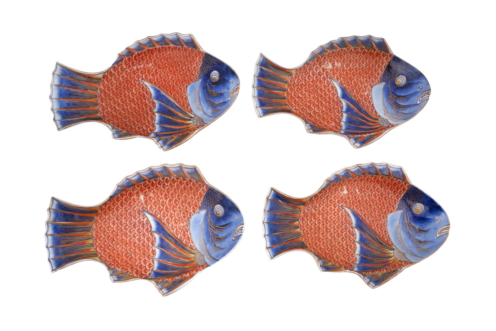 A SET OF FOUR JAPANESE IMARI 'FISH' DISHES Early 20th century: A SET OF FOUR JAPANESE IMARI 'FISH' DISHES Early 20th century Each formed as a snapper with a scaly body, decorated with underglaze blue, overglaze red enamels and details picked out with gilt, the re