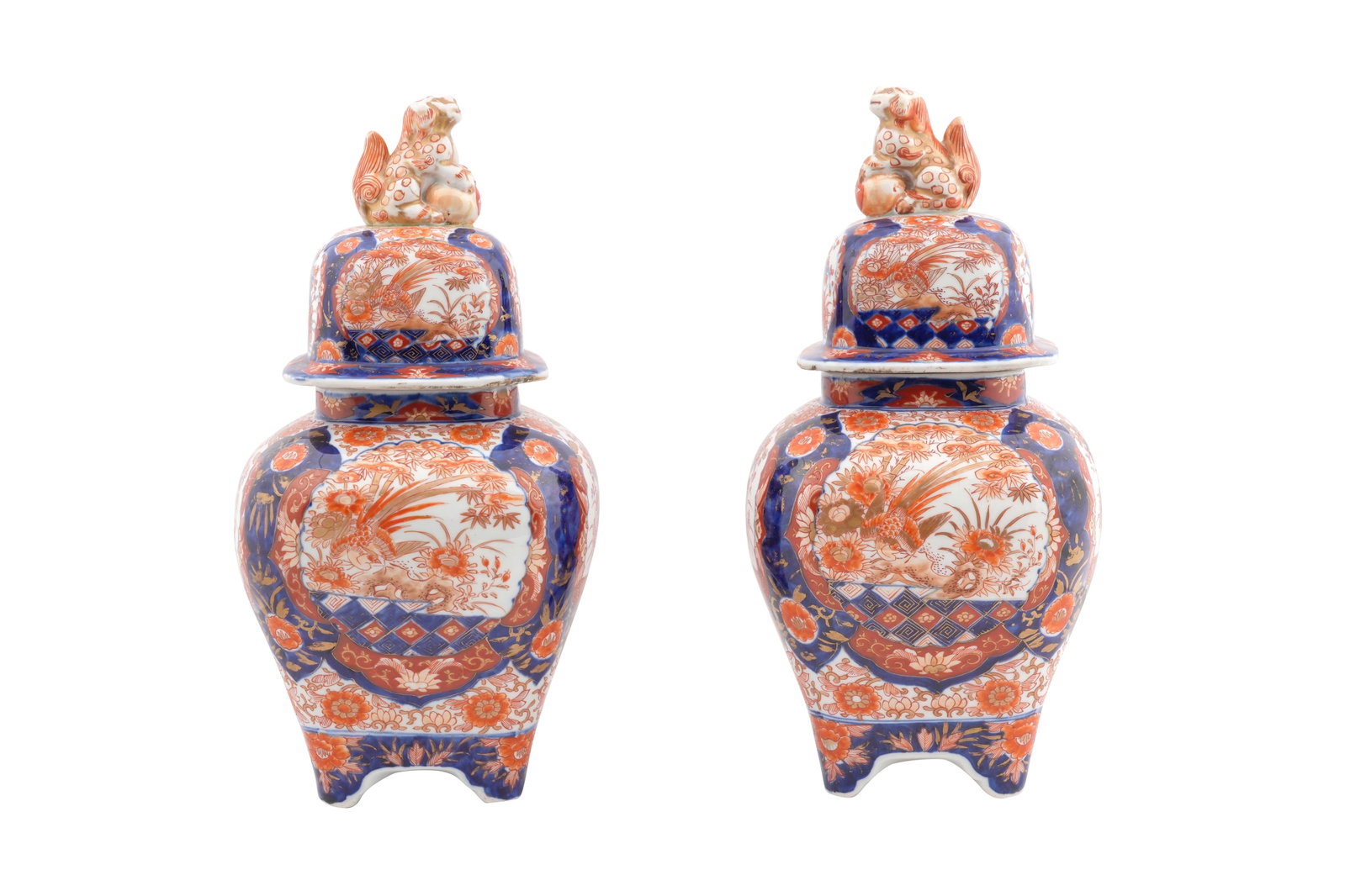 A PAIR OF JAPANESE IMARI JARS AND COVERS Meiji / Taisho period: A PAIR OF JAPANESE IMARI JARS AND COVERS Meiji / Taisho period Each with a flared body rising from four short braket feet to a rounded shoulder with a short neck, painted with in the typical Imari pal