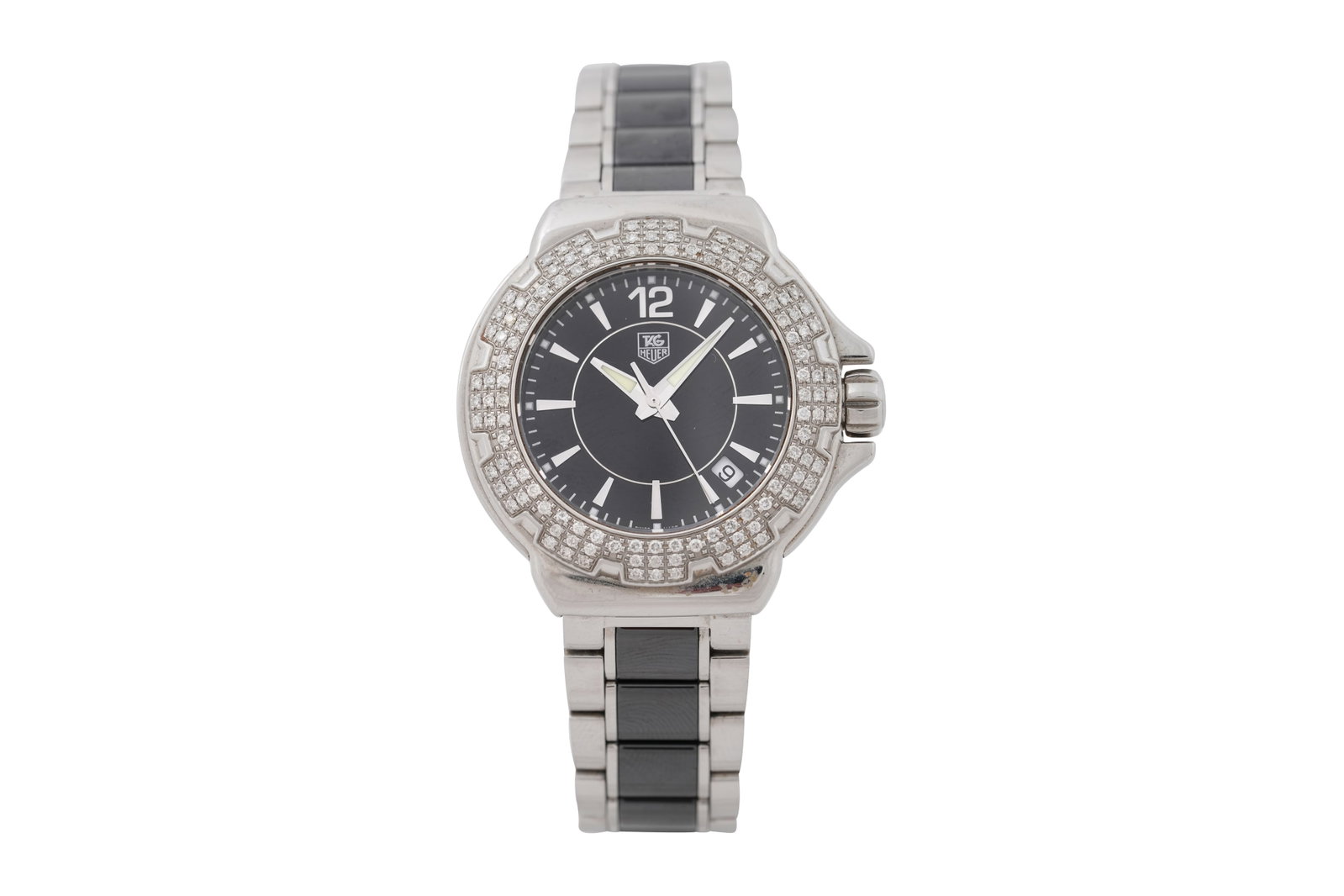 A TAG HEUER LADIES FORMULA 1 BRACELET WATCH WAH12 series: A TAG HEUER LADIES FORMULA 1 BRACELET WATCH An earlier model without the 'Formula 1' inscription to the dial, water resistant to 200m, with a round cut diamond bezel, the black face with blank numeral