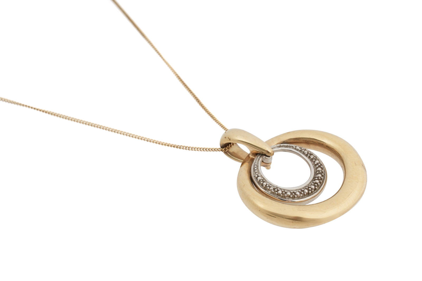 A 9CT YELLOW AND WHITE GOLD PENDANT NECKLACE: A 9CT YELLOW AND WHITE GOLD PENDANT NECKLACE With a fine 9ct gold chain, suspending a pendant of two offset, assymetrical rings, the inner illusion ring of 9ct white gold, the outer of 9ct yellow gold