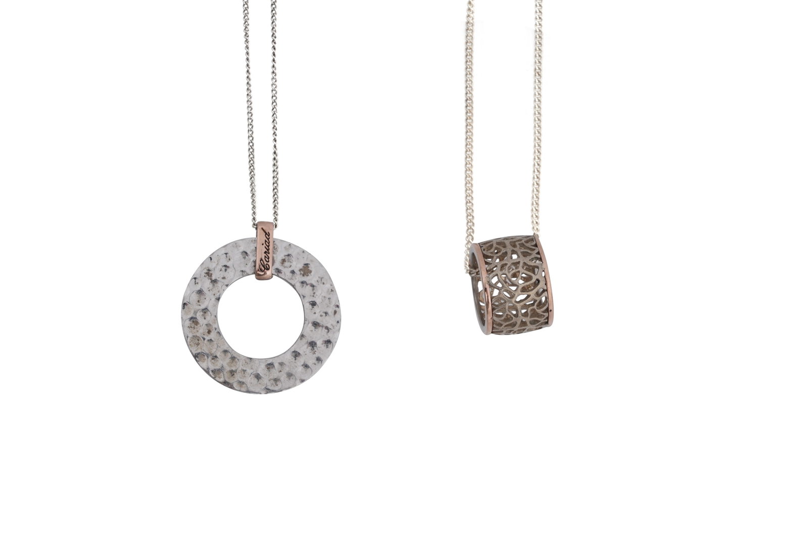TWO BOXED SILVER CLOGAU NECKLACE AND PENDANTS: TWO BOXED SILVER CLOGAU PENDANT NECKLACES Each with a fine silver chain marked '925' to the clasp, one with a magnetic clasp, one hammered disk pendant, the other hoop pendant of pierced design, both 