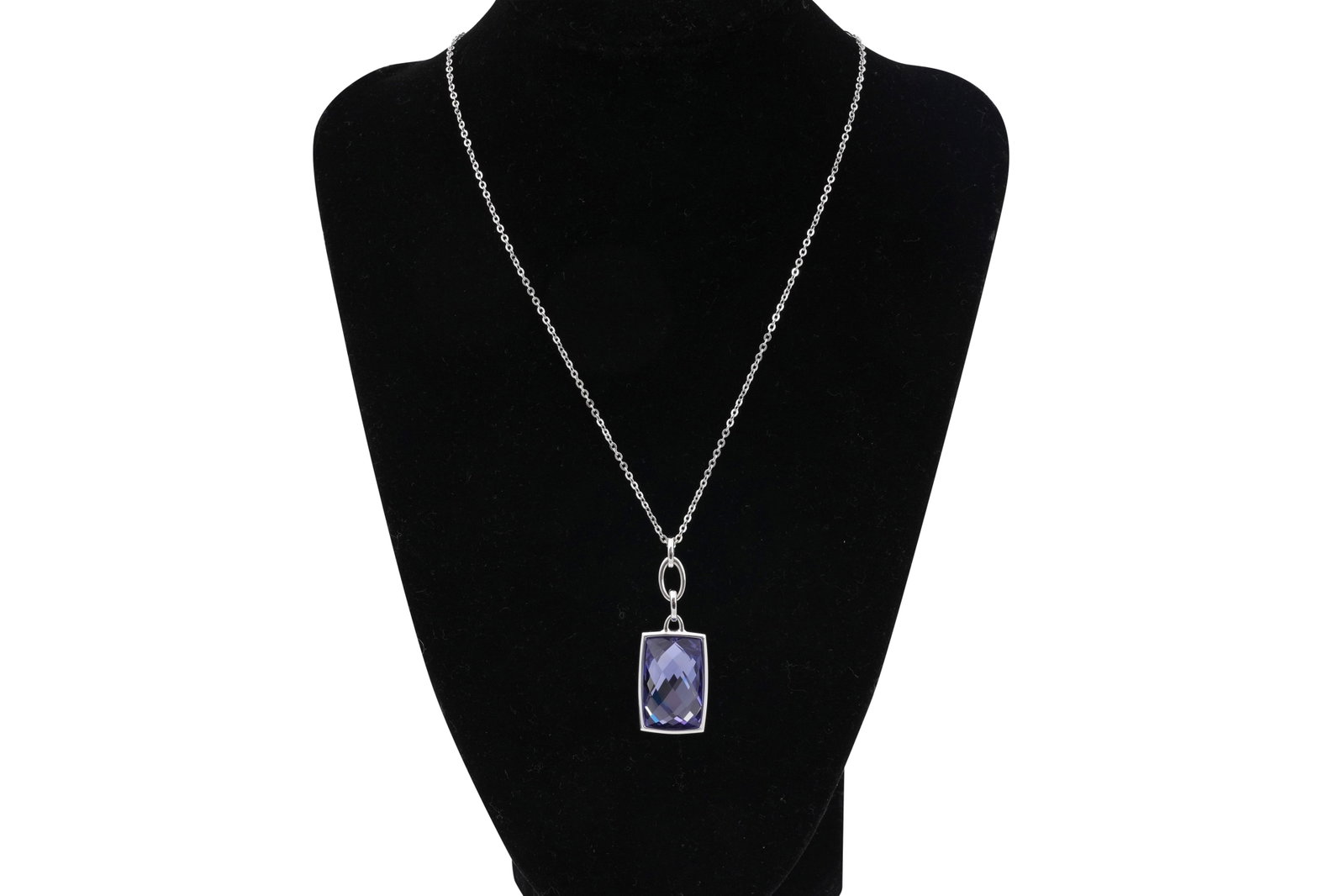 A SWAROVSKI RHODIUM-PLATED 'TANZANITE' COLOUR CRYSTAL PENDANT NECKLACE: A SWAROVSKI RHODIUM-PLATED 'TANZANITE' COLOUR CRYSTAL PENDANT NECKLACE A Swarovski rhodium-plated pendant necklace set with a faceted deep violet-blue crystal in an angular geometric mount