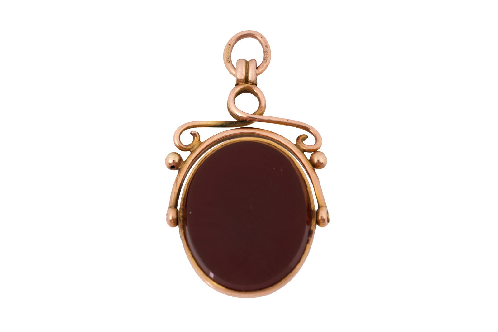 A LATE 19TH CENTURY BLOODSTONE AND CARNELIAN FOB SEAL: A LATE 19TH CENTURY BLOODSTONE AND CARNELIAN FOB SEAL Set in a 9ct gold swivel mount, with a scrolling stem and loop adorned with gold granules, marked '375'. Gross weight 3.8grs; length 3cm