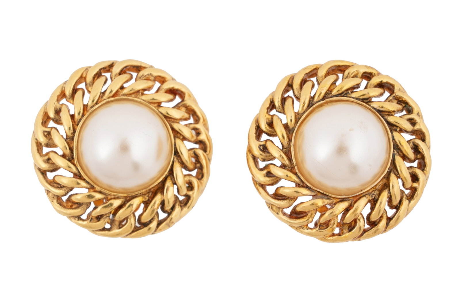 A PAIR OF BOXED CHANEL VINTAGE FAUX PEARL AND GOLD-TONE CLIP EARRINGS Made in France, c.1990s: A PAIR OF BOXED CHANEL VINTAGE FAUX PEARL AND GOLD-TONE CLIP EARRINGS Made in France, c.1990s A pair of classic Chanel gold-tone clip earrings, each centred with a large faux pearl cabochon within a t