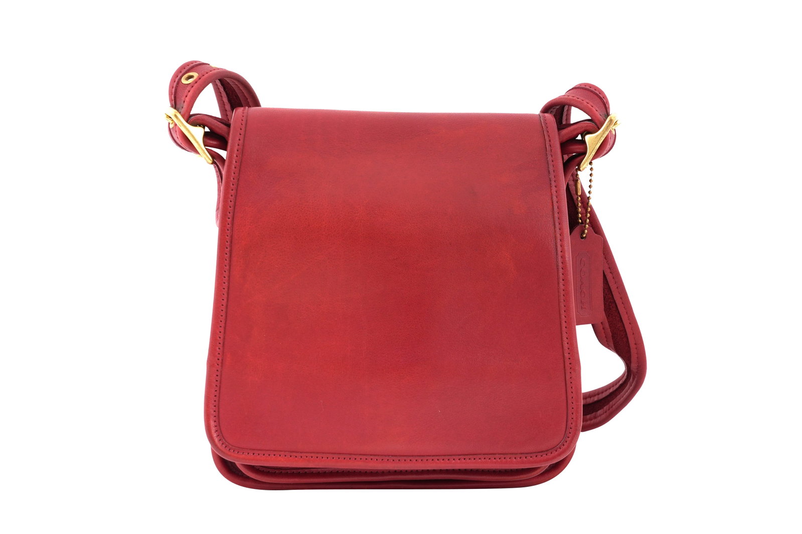 A VINTAGE COACH LIPSTICK RED LEATHER SHOULDER BAG WITH ADJUSTABLE STRAP USA, c.1990-2000s: A VINTAGE COACH LIPSTICK RED LEATHER SHOULDER BAG WITH ADJUSTABLE STRAP USA, c.1990-2000s [A] A particularly striking vintage Coach shoulder bag in a vivid lipstick-red leather, offering a bold yet ti