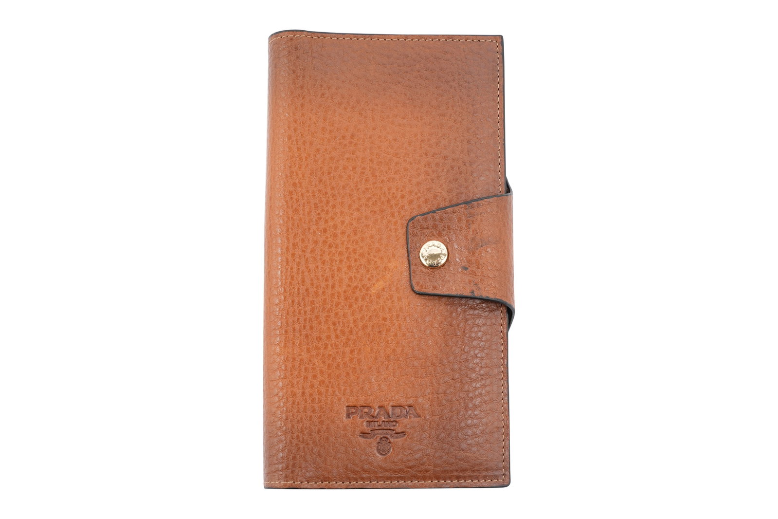 A PRADA GRAINED TANNED LEATHER CONTINENTAL WALLET Made in Italy, c.2010: A PRADA GRAINED TANNED LEATHER CONTINENTAL WALLET Made in Italy, c.2010 Finely crafted Prada continental tri-fold supple tan grained calf-leather Vitello Move Wallet with flap and gilt press stud fast
