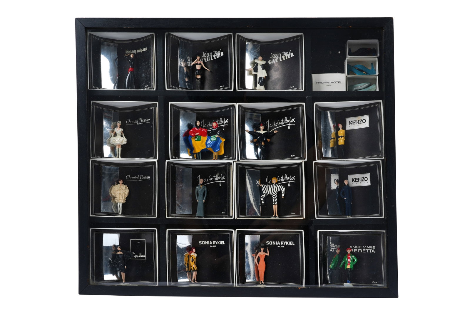 A COLLECTION OF 18 PIXI 'MODE: LA HAUTE COUTURE' MINIATURE FASHION DESIGNER FIGURINES IN DISPLAY: A COLLECTION OF EIGHTEEN PIXI 'MODE: LA HAUTE COUTURE' MINIATURE FASHION DESIGNER FIGURINES IN DISPLAY BOX Probably France, c.1980s In 1986, the French creator Pixi released a highly sought-after line