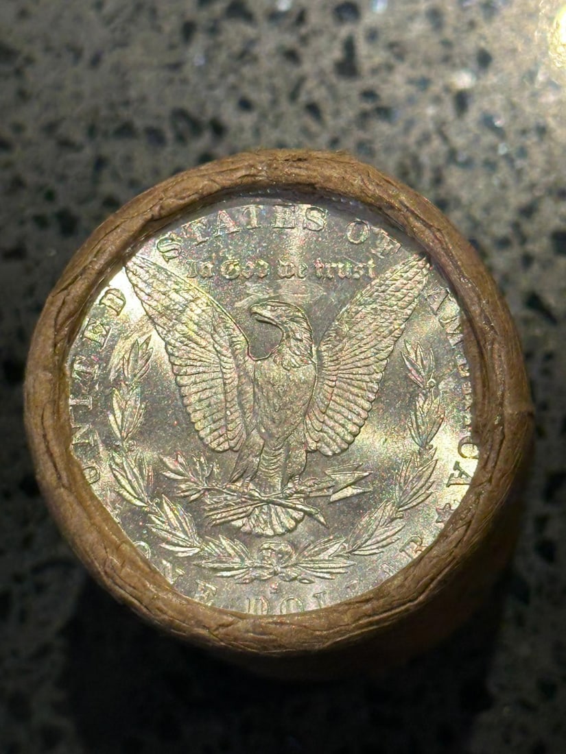 BU $10 Morgan Silver Dollar Roll S & O Ends: An original Brilliant Uncirculated (BU) sealed roll of Morgan Silver Dollars, featuring a San Francisco (S) Mint coin on one end and a New Orleans (O) Mint coin on the opposite end. The roll remains