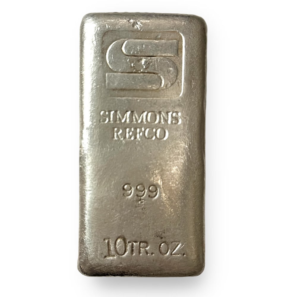 Vintage Poured Simmons Refco 10 oz Bar (Type A): The Vintage Poured Simmons Refco 10 oz Silver Bar (Type A) contains 10 troy ounces of .999 fine silver and features a classic hand-poured design with stamped refinery markings. Produced by Simmons Ref