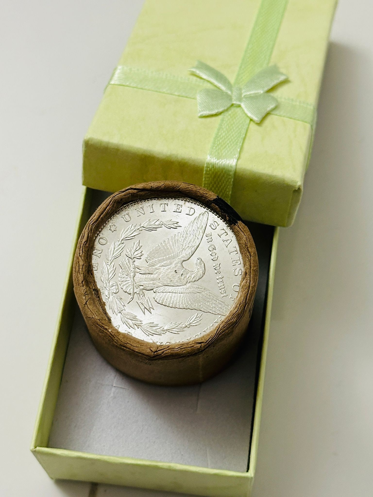 BU $20 Morgan Silver Dollar Roll CC & CC Ends: An original Brilliant Uncirculated (BU) sealed roll of Morgan Silver Dollars, featuring a Carson City (CC) Mint coin on both ends. The roll remains sealed, with only the front and back coins visible.