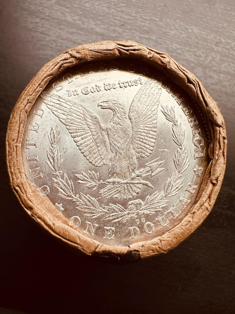 BU $10 Morgan Silver Dollar Roll CC & CC Ends: An original Brilliant Uncirculated (BU) sealed roll of Morgan Silver Dollars, featuring a Carson City (CC) Mint coin on both ends. The roll remains sealed, with only the front and back coins visible.