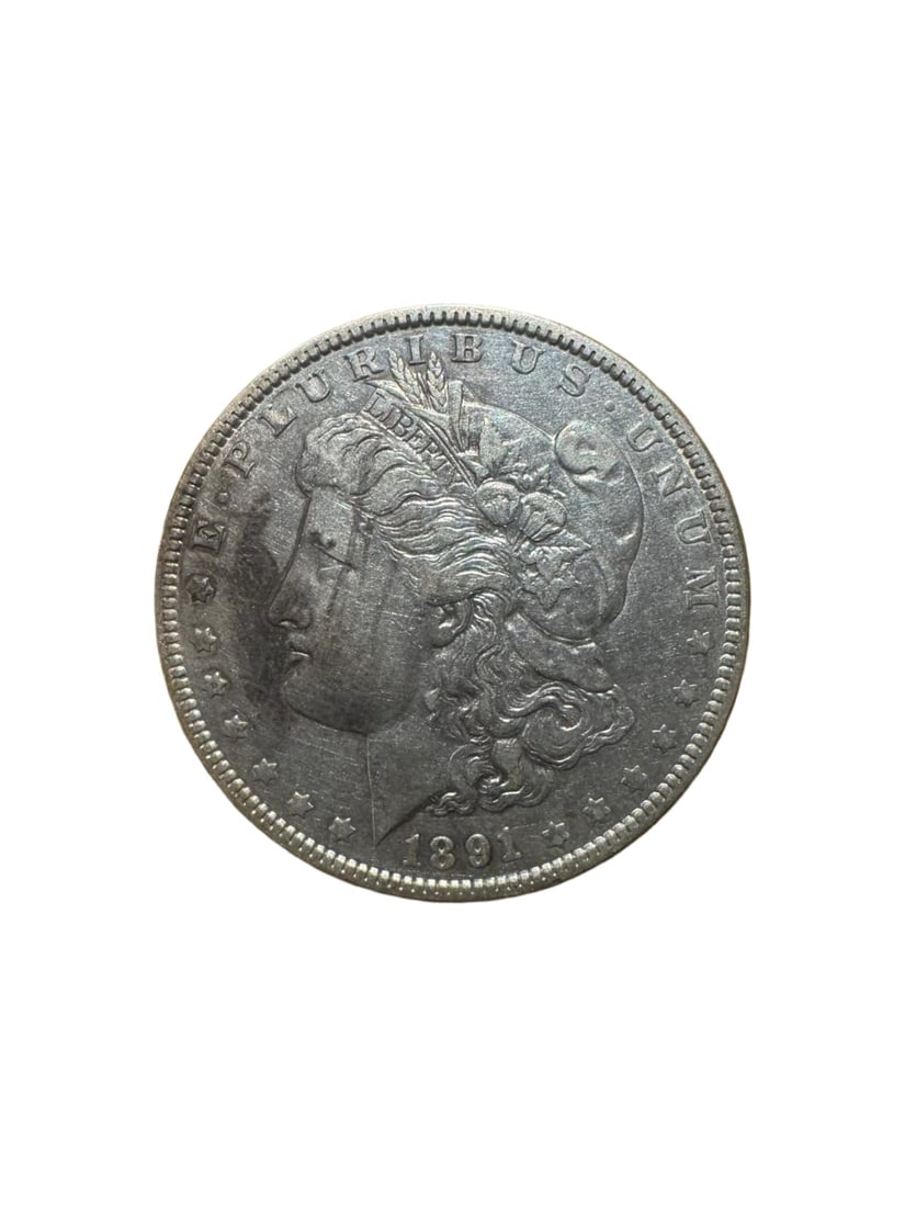 Morgan dollar 1891-O XF: This 1891-O Morgan Silver Dollar from the New Orleans Mint is struck in 90% silver. It displays the iconic Liberty and eagle motifs of the Morgan series. In XF condition, it shows light circulation we