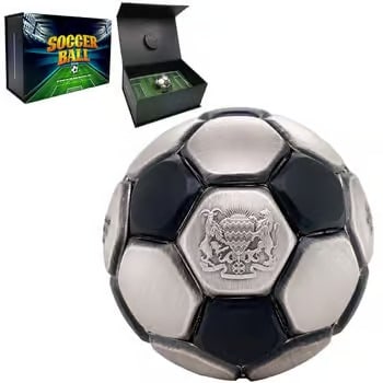 2022 Chad 30 Gram Silver Soccer Ball Spherical Antiqued Coin .999 Fine: This 2022 Chad 30g Silver Coin is uniquely shaped like a soccer ball with an antiqued finish. Struck in .999 fine silver, it features realistic panel detailing across its spherical form. The aged fini