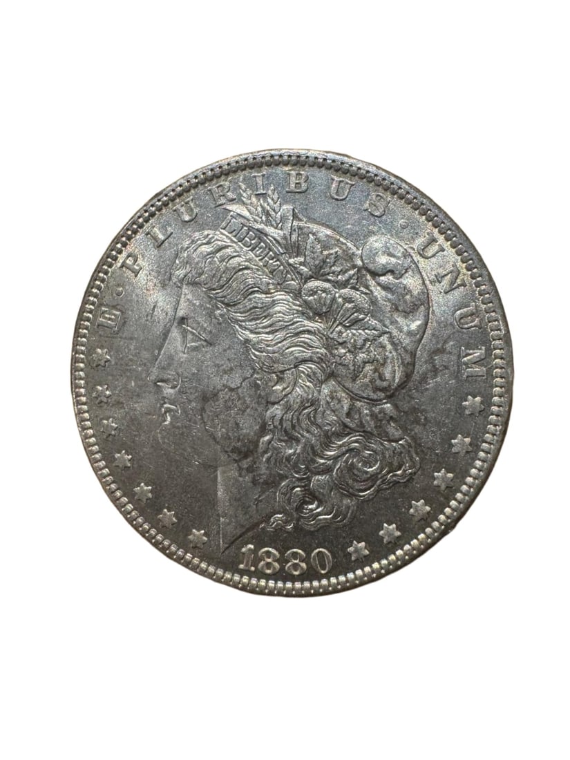 Morgan dollar 1880-O AU: The 1880-O Morgan Silver Dollar was minted in New Orleans and struck in 90% silver. It displays the classic Liberty and eagle design with strong detail. In About Uncirculated (AU) condition, the coin 