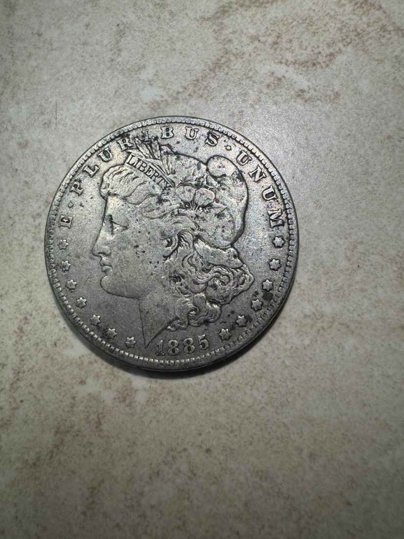 1885 Morgan Dollar - VF35 (Non-Graded): A well-preserved 1885 Morgan Silver Dollar struck in 90% silver with strong remaining detail. Graded approximately Very Fine (VF35), this example shows light to moderate wear with clear design element