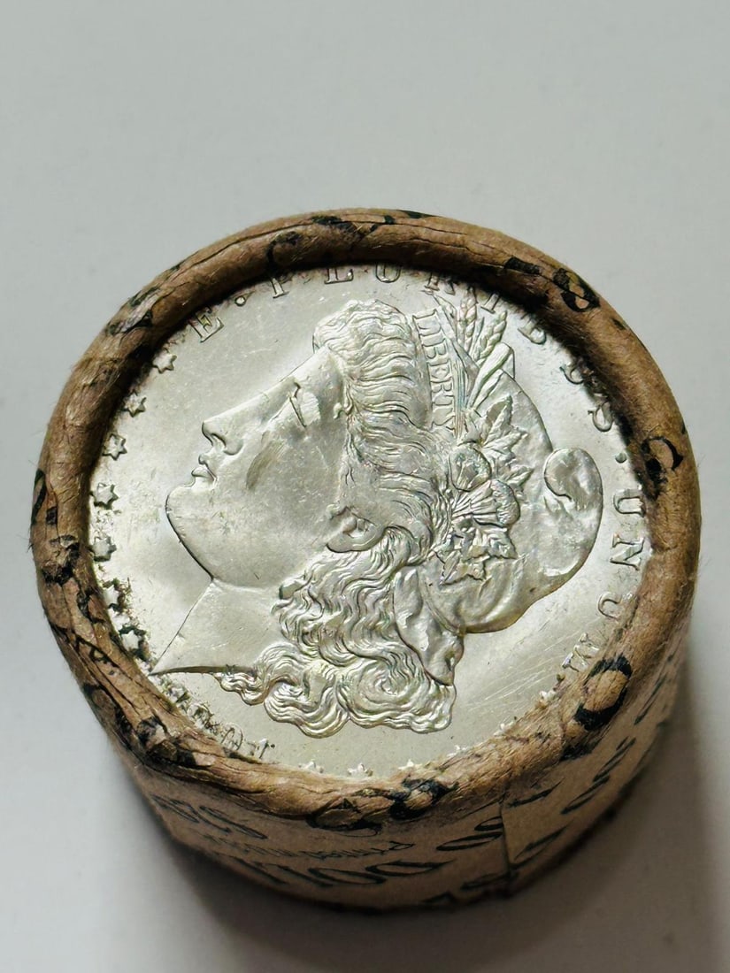 BU $10 Morgan Silver Dollar Roll 1899 & 1901 Ends: An original Brilliant Uncirculated (BU) sealed roll of Morgan Silver Dollars, featuring an 1899 coin on one end and a 1901 coin on the opposite end. The roll remains sealed, with only the front and ba