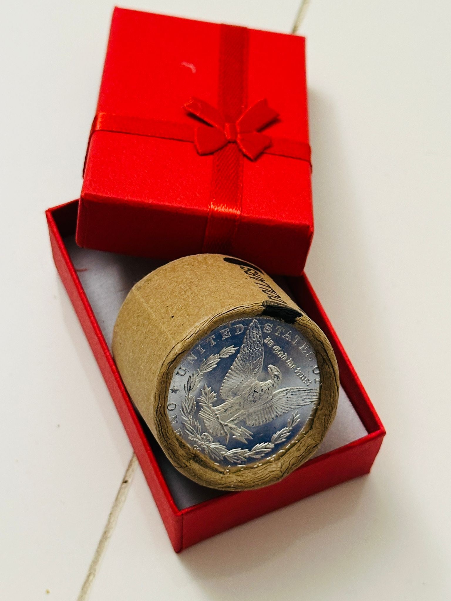 BU $10 Morgan Silver Dollar Roll 1885 & CC Ends: An original Brilliant Uncirculated (BU) sealed roll of Morgan Silver Dollars, featuring an 1885 coin on one end and a Carson City (CC) Mint coin on the opposite end. The roll remains sealed, with only