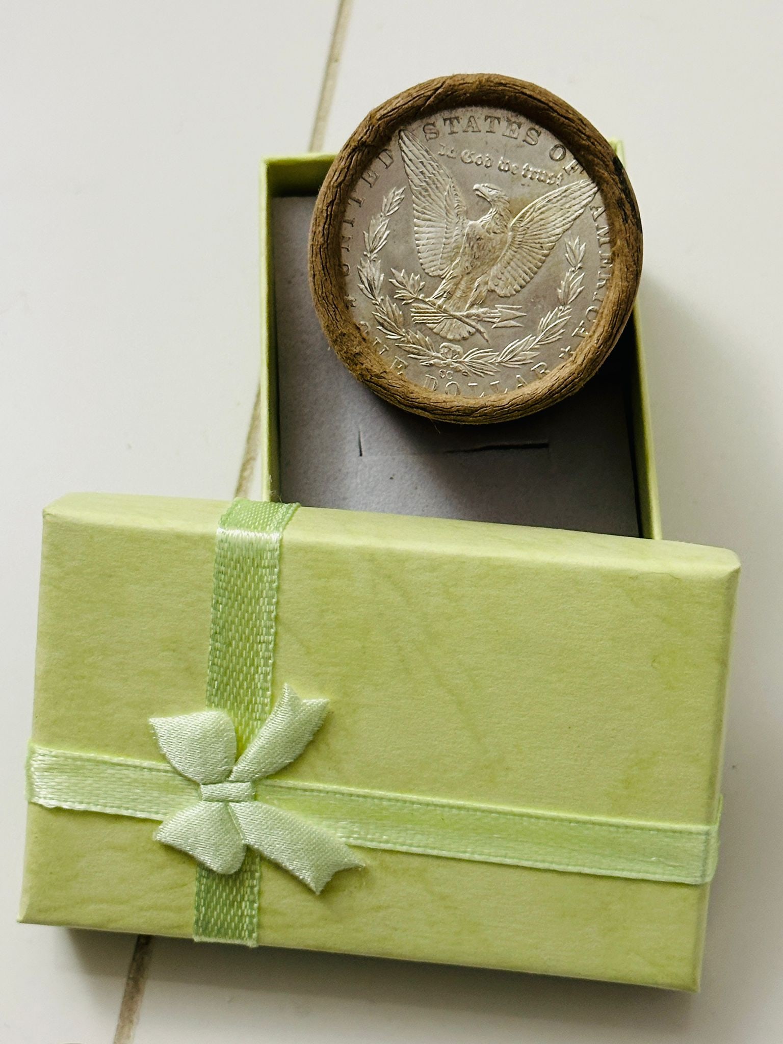 BU $20 Morgan Silver Dollar Roll O & CC Ends: An original Brilliant Uncirculated (BU) sealed roll of Morgan Silver Dollars, featuring a New Orleans (O) Mint coin on one end and a Carson City (CC) Mint coin on the opposite end. The roll remains se