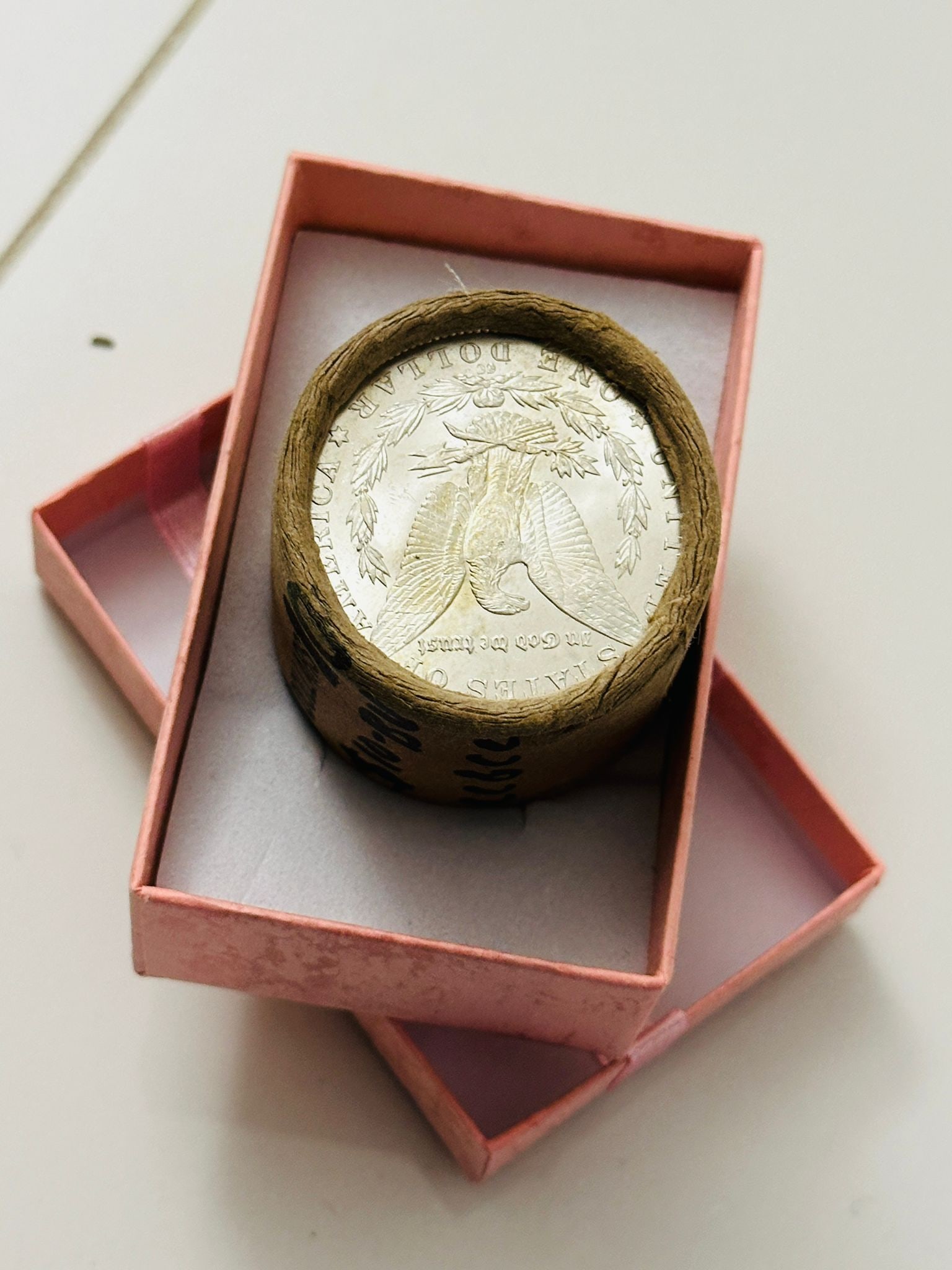 BU $20 Morgan Silver Dollar Roll S & CC Ends: An original Brilliant Uncirculated (BU) sealed roll of Morgan Silver Dollars, featuring a San Francisco Mint coin on one end and a Carson City (CC) Mint coin on the opposite end. The roll remains seal
