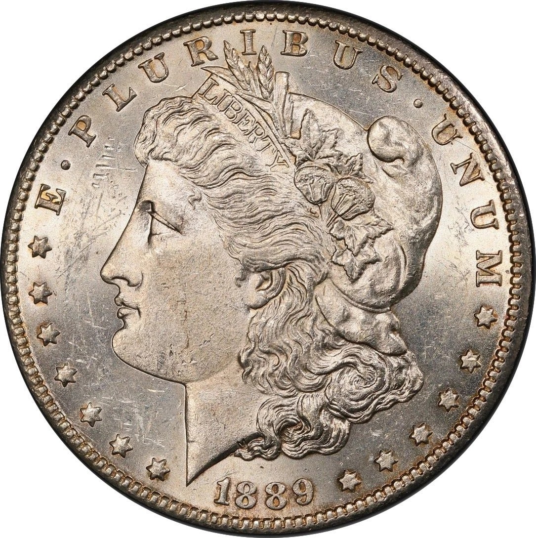 1889-CC MORGAN S$1 MS 62+ Non graded: The Morgan Dollar 1889-CC is the rarest and most coveted Carson City issue, renowned as the key date of the entire CC series. In MS-62+ condition, this 90% silver classic displays strong mint luster, 