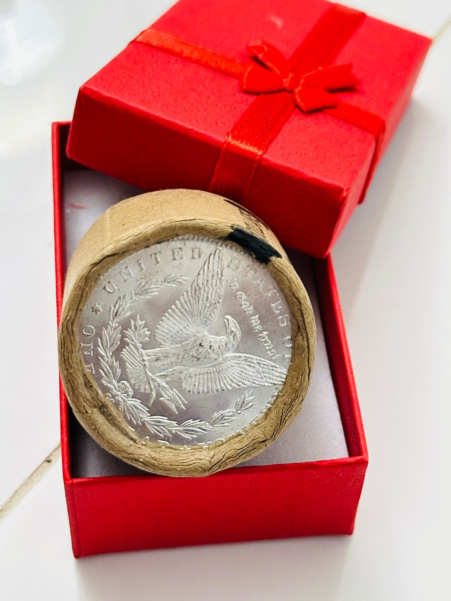 BU $10 Morgan Silver Dollar Roll 1881 & CC Ends: An original Brilliant Uncirculated (BU) sealed roll of Morgan Silver Dollars, featuring an 1881 coin on one end and a Carson City (CC) Mint coin on the opposite end. The roll remains sealed, with only