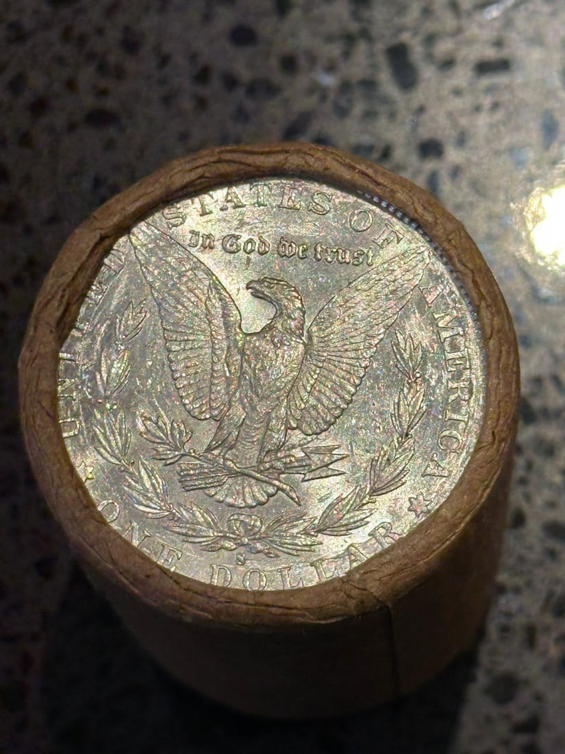 BU $10 Morgan Silver Dollar Roll S & CC Ends: An original Brilliant Uncirculated (BU) sealed roll of Morgan Silver Dollars, featuring a San Francisco (S) Mint coin on one end and a Carson City (CC) Mint coin on the opposite end. The roll remains 