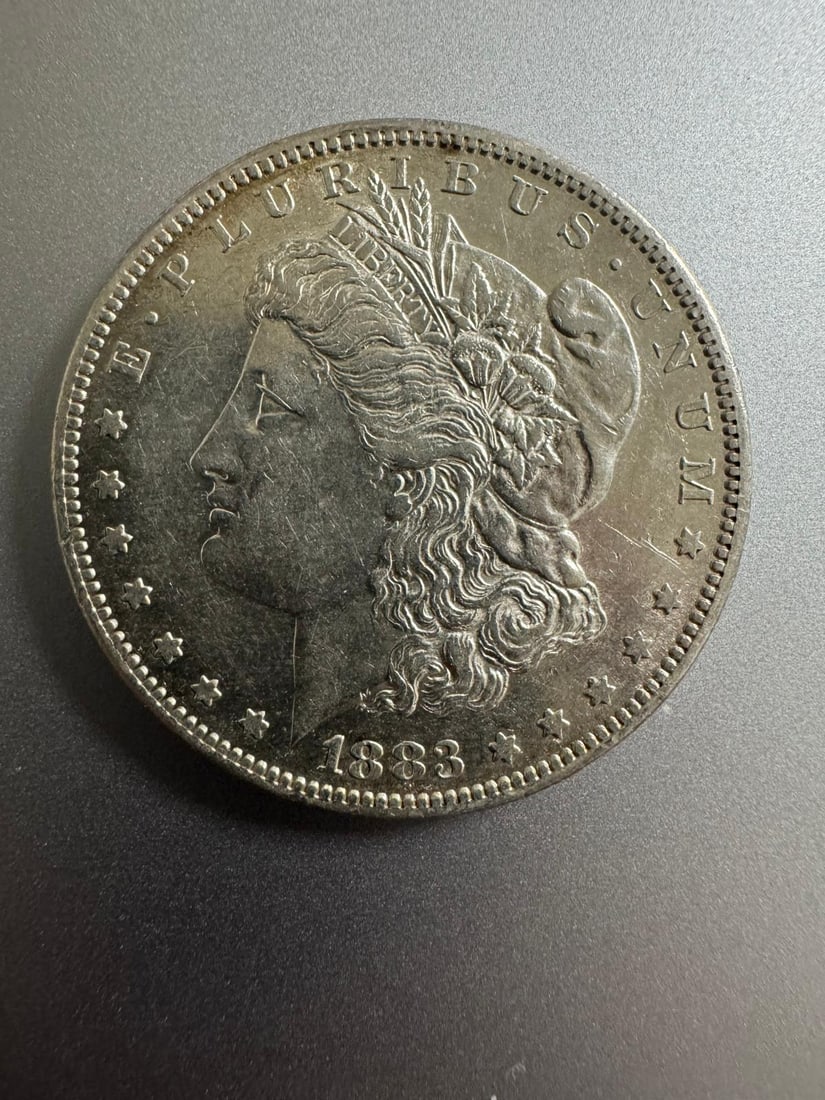 1883-S Morgan dollar - AU: he 1883-S Morgan Dollar AU (Non-Graded) is a higher-grade example with light wear and traces of original mint luster. As an About Uncirculated coin from the San Francisco Mint, it is especially desira