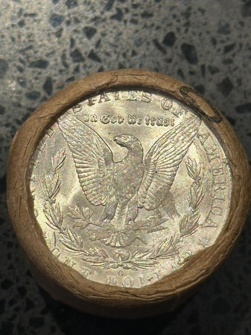 BU $10 Morgan Silver Dollar Roll O & CC Ends: An original Brilliant Uncirculated (BU) sealed roll of Morgan Silver Dollars, featuring a New Orleans (O) Mint coin on one end and a Carson City (CC) Mint coin on the opposite end. The roll remains se