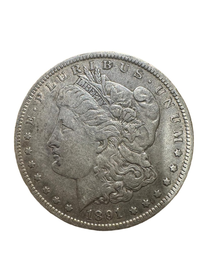 Morgan dollar 1891-O XF: The 1891-O Morgan Silver Dollar is a historic coin struck at the New Orleans Mint. Composed of 90% silver, it features the classic Lady Liberty and eagle design. In Extremely Fine (XF) condition, the 