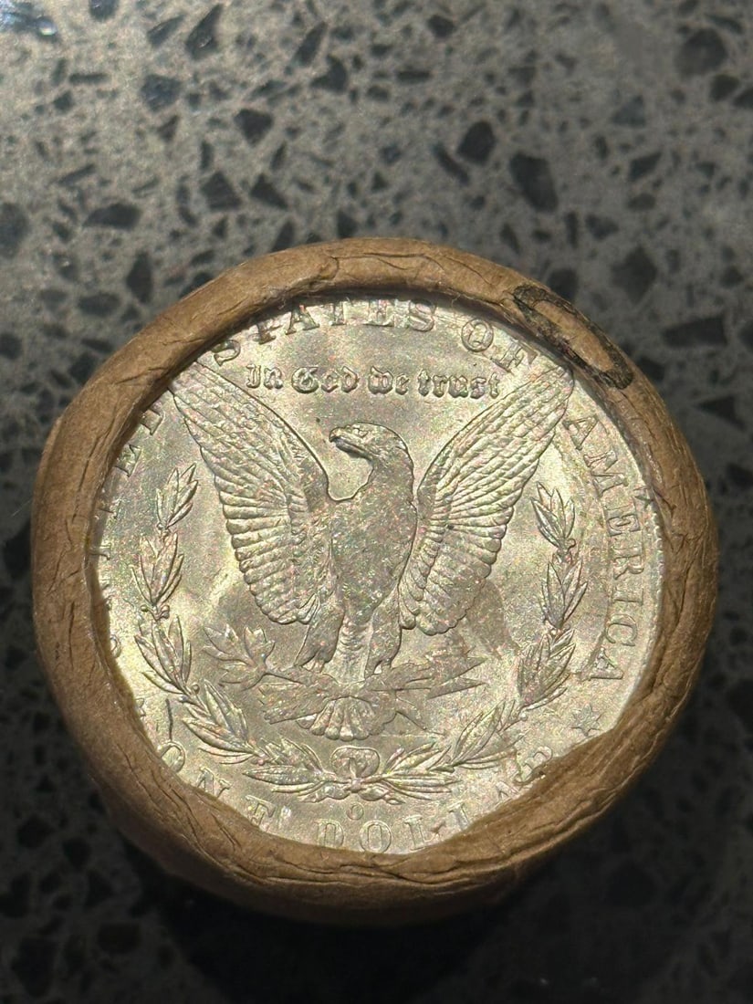 BU $20 Morgan Silver Dollar Roll O & O Ends: An original Brilliant Uncirculated (BU) sealed roll of Morgan Silver Dollars, featuring a New Orleans (O) Mint coin on both ends. The roll remains sealed, with only the front and back coins visible. A