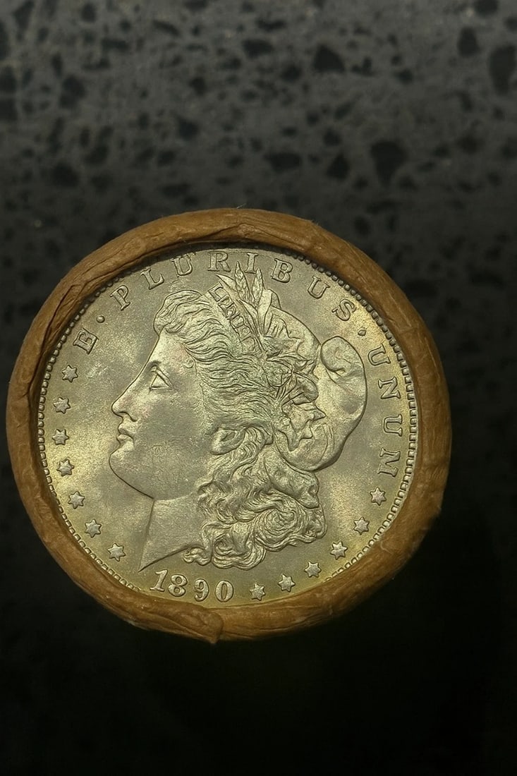 BU $10 Morgan Silver Dollar Roll 1890 & 1891 Ends: An original Brilliant Uncirculated (BU) sealed roll of Morgan Silver Dollars, featuring an 1890 coin on one end and an 1891 coin on the opposite end. The roll remains sealed, with only the front and b