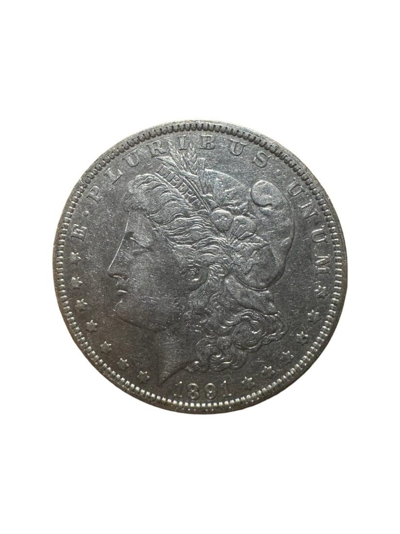 Morgan dollar 1891-O XF: This 1891-O Morgan Silver Dollar from the New Orleans Mint is a classic 90% silver coin. It features the timeless Morgan design with clear Liberty and eagle details. In XF condition, it shows light ci