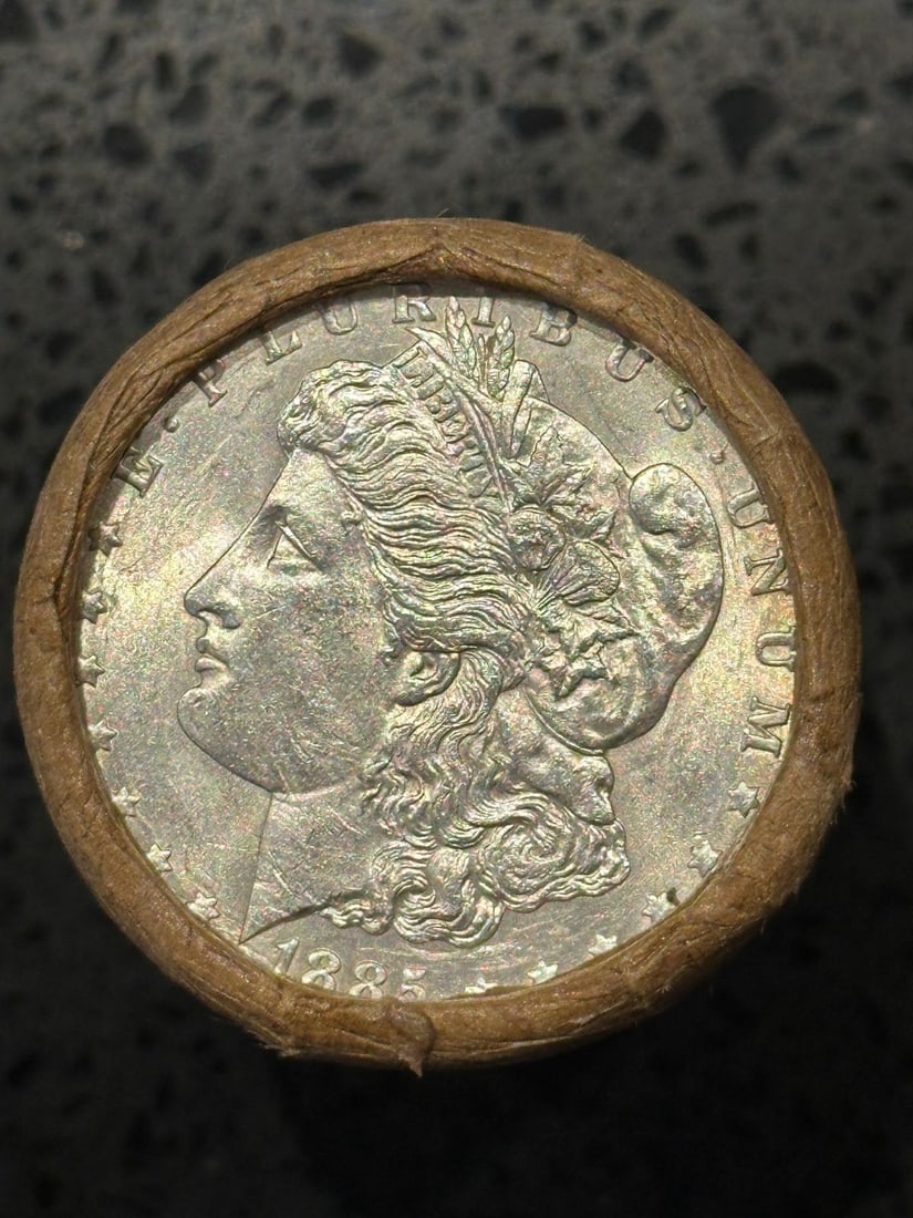 BU $20 Morgan Silver Dollar Roll 1885 & CC Ends: An original Brilliant Uncirculated (BU) sealed roll of Morgan Silver Dollars, featuring an 1885-dated coin on one end and a Carson City (CC) Mint coin on the opposite end. The roll remains sealed with