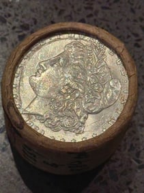 BU $20 Morgan Silver Dollar Roll 1889 & CC Ends: An original Brilliant Uncirculated (BU) sealed roll of Morgan Silver Dollars, featuring an 1889-dated coin on one end and a Carson City (CC) Mint coin on the opposite end. The roll remains sealed with