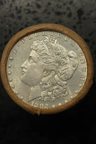 BU $10 Morgan Silver Dollar Roll 1902 & CC Ends: An original Brilliant Uncirculated (BU) sealed roll of Morgan Silver Dollars, featuring a 1902 coin on one end and a Carson City (CC) Mint coin on the opposite end. The roll remains sealed, with only 