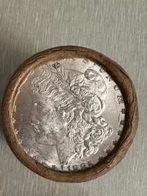 BU $20 Morgan Silver Dollar Roll 1885 & CC Ends: An original Brilliant Uncirculated (BU) sealed roll of Morgan Silver Dollars, featuring an 1885-dated coin on one end and a Carson City (CC) Mint coin on the opposite end. The roll remains sealed with