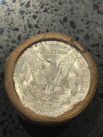 BU $10 Morgan Silver Dollar Roll O & CC Ends: An original Brilliant Uncirculated (BU) sealed roll of Morgan Silver Dollars, featuring a New Orleans (O) Mint coin on one end and a Carson City (CC) Mint coin on the opposite end. The roll remains se