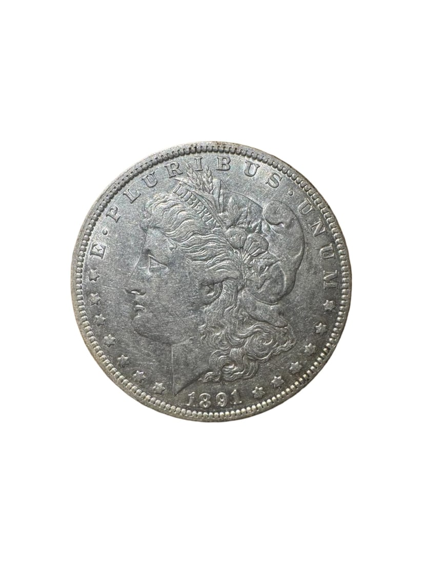 Morgan dollar 1891-O XF: The 1891-O Morgan Silver Dollar was minted in New Orleans and struck in 90% silver. It showcases the iconic Lady Liberty and heraldic eagle design. In Extremely Fine (XF) condition, the coin retains s