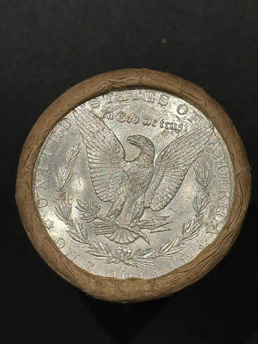 BU $20 Morgan Silver Dollar Roll CC & CC Ends: An original Brilliant Uncirculated (BU) sealed roll of Morgan Silver Dollars, featuring a Carson City (CC) Mint coin on both ends. The roll remains sealed, with only the front and back coins visible. 