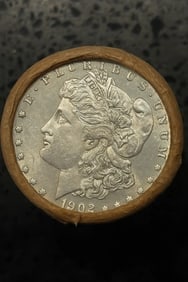 BU $10 Morgan Silver Dollar Roll 1902 & CC Ends: An original Brilliant Uncirculated (BU) sealed roll of Morgan Silver Dollars, featuring a 1902 coin on one end and a Carson City (CC) Mint coin on the opposite end. The roll remains sealed, with only 