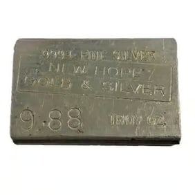 9.88 oz New Hope Gold & Silver Vintage Silver Bar .999+ Fine: This 9.88 oz Silver Bar by New Hope Gold & Silver is a unique vintage piece. Struck in .999+ fine silver, its uncommon weight adds collectible interest. The traditional design reflects classic bullion