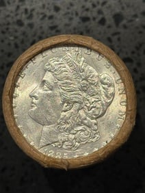 BU $20 Morgan Silver Dollar Roll 1885 & CC Ends: An original Brilliant Uncirculated (BU) sealed roll of Morgan Silver Dollars, featuring an 1885-dated coin on one end and a Carson City (CC) Mint coin on the opposite end. The roll remains sealed with